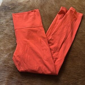 Athleta Transcend Stash Tight in Bold Orange